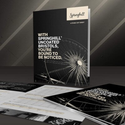 Springhill branded booklets on a dark surface with a spotlight effect.